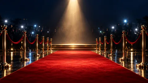 A red carpet beneath spotlights and a stormy sky.