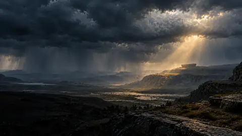 Storm clouds and rain gathering over an ancient landscape